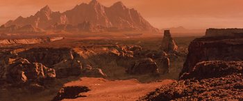 Movie still from “Red Planet” (2000), directed by Antony Hoffman – An image of an alien landscape with mountains in the background; Extreme Wide shot, High angle