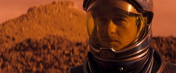 Movie still from “Red Planet” (2000), directed by Antony Hoffman – A man in a space suit and a helmet; Close Up shot, Over the shoulder angle