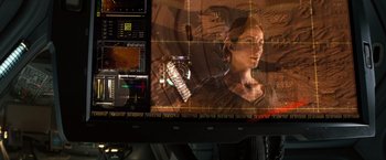 Movie still from “Red Planet” (2000), directed by Antony Hoffman – A picture of a woman on a large screen; Close Up shot, Over the shoulder angle