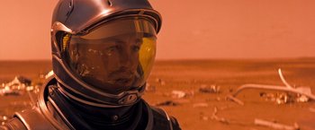 Movie still from “Red Planet” (2000), directed by Antony Hoffman – A man wearing a helmet on the surface of mars; Close Up shot, Over the shoulder angle