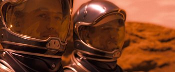 Movie still from “Red Planet” (2000), directed by Antony Hoffman – A person wearing a space suit; Close Up shot, High angle