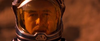 Movie still from “Red Planet” (2000), directed by Antony Hoffman – A person wearing a space helmet; Close Up shot, Over the shoulder angle
