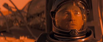 Movie still from “Red Planet” (2000), directed by Antony Hoffman – A man in a space suit looking into the distance; Close Up shot, Low angle