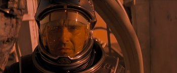 Movie still from “Red Planet” (2000), directed by Antony Hoffman – A person wearing a space suit; Close Up shot, Low angle