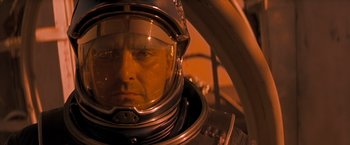 Movie still from “Red Planet” (2000), directed by Antony Hoffman – A person wearing a space suit; Close Up shot, Low angle