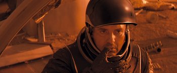 Movie still from “Red Planet” (2000), directed by Antony Hoffman – A person wearing a space suit; Close Up shot, Overhead angle