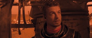 Movie still from “Red Planet” (2000), directed by Antony Hoffman – A person wearing a space suit; Close Up shot, Over the shoulder angle