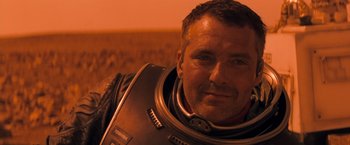 Movie still from “Red Planet” (2000), directed by Antony Hoffman – A person wearing a space suit; Close Up shot, Low angle