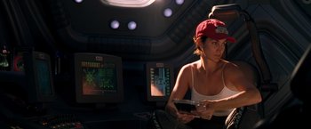 Movie still from “Red Planet” (2000), directed by Antony Hoffman – A woman sitting on a chair in front of a computer screen; Medium shot, Over the shoulder angle