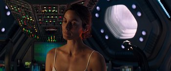 Movie still from “Red Planet” (2000), directed by Antony Hoffman – A woman in a white tank top is in a spaceship; Close Up shot, Over the shoulder angle
