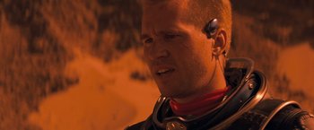 Movie still from “Red Planet” (2000), directed by Antony Hoffman – A person wearing headphones; Close Up shot, Over the shoulder angle