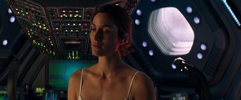 Movie still from “Red Planet” (2000), directed by Antony Hoffman – A woman in a white tank top is in a spaceship; Close Up shot, Over the shoulder angle