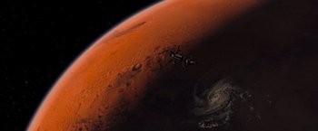 Movie still from “Red Planet” (2000), directed by Antony Hoffman – An image of a space ship in the sky above the earth; Extreme Wide shot, Overhead angle