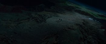 Movie still from “Red Planet” (2000), directed by Antony Hoffman – Two people are walking on the beach at night; Extreme Wide shot, Overhead angle