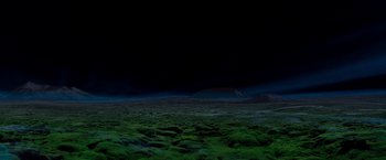 Movie still from “Red Planet” (2000), directed by Antony Hoffman – A view of a dark sky and a green field; Extreme Wide shot, High angle