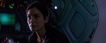 Movie still from “Red Planet” (2000), directed by Antony Hoffman – A woman wearing a headset in a dark room; Close Up shot, Over the shoulder angle