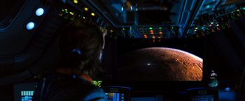 Movie still from “Red Planet” (2000), directed by Antony Hoffman – A person is looking at a screen with a picture of a planet; Extreme Wide shot, High angle