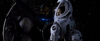 Movie still from “Red Planet” (2000), directed by Antony Hoffman – A person in a space suit in a space ship; Medium shot, Overhead angle