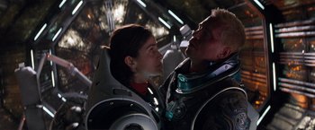 Movie still from “Red Planet” (2000), directed by Antony Hoffman – A man and a woman in a space suit looking at each other; Close Up shot, Low angle