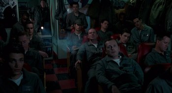 Movie still from “Rescue Dawn” (2006), directed by Werner Herzog – A group of men sitting in a room; Medium shot, High angle