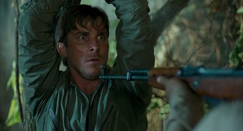 Movie still from “Rescue Dawn” (2006), directed by Werner Herzog – A man holding a rifle up to his head; Close Up shot, Low angle