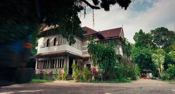 Movie still from “Rescue Dawn” (2006), directed by Werner Herzog – An old house with a lot of plants in front of it; Extreme Wide shot, Low angle