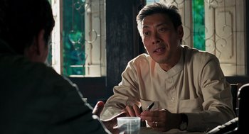 Movie still from “Rescue Dawn” (2006), directed by Werner Herzog – A man sitting at a table with a pen in his hand; Close Up shot, Over the shoulder angle