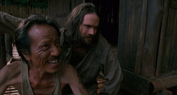 Movie still from “Rescue Dawn” (2006), directed by Werner Herzog – A man sitting next to a man with a beard; Close Up shot, Low angle