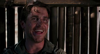 Movie still from “Rescue Dawn” (2006), directed by Werner Herzog – A person smiling; Close Up shot, Low angle