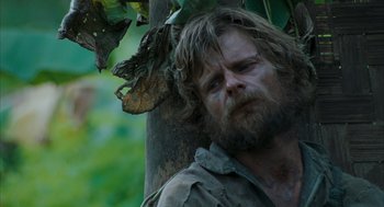 Movie still from “Rescue Dawn” (2006), directed by Werner Herzog – A person near a tree; Close Up shot, Low angle