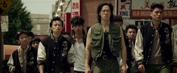 Movie still from “Revenge of the Green Dragons” (2014), directed by Andrew Loo – A group of young men walking down a street; Medium shot, Low angle
