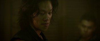 Movie still from “Revenge of the Green Dragons” (2014), directed by Andrew Loo – A person with long black hair; Close Up shot, Low angle