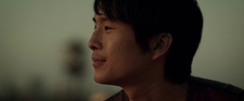 Movie still from “Revenge of the Green Dragons” (2014), directed by Andrew Loo – A young man's face; Close Up shot, Low angle