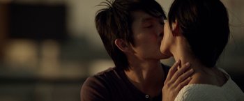 Movie still from “Revenge of the Green Dragons” (2014), directed by Andrew Loo – A man kissing another man on the cheek; Close Up shot, Over the shoulder angle