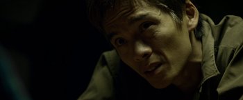 Movie still from “Revenge of the Green Dragons” (2014), directed by Andrew Loo – A man's face in the dark; Close Up shot, High angle