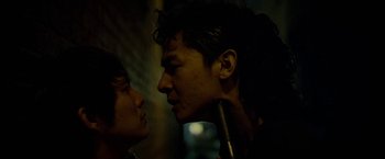 Movie still from “Revenge of the Green Dragons” (2014), directed by Andrew Loo – A man and a woman face to face in the dark; Close Up shot, Over the shoulder angle