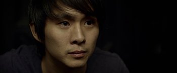 Movie still from “Revenge of the Green Dragons” (2014), directed by Andrew Loo – A person with long hair; Close Up shot, High angle