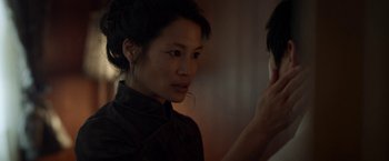 Movie still from “Revenge of the Green Dragons” (2014), directed by Andrew Loo – A woman looking into a mirror while standing next to another woman; Close Up shot, Over the shoulder angle