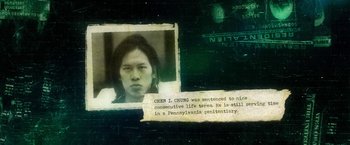 Movie still from “Revenge of the Green Dragons” (2014), directed by Andrew Loo – An old photo of a person with a caption on it; Extreme Close Up shot, Overhead angle