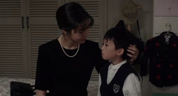 Movie still from “Ringu” (1998), directed by Hideo Nakata – A young boy and a woman are looking at each other; Close Up shot, Over the shoulder angle