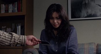 Movie still from “Ringu” (1998), directed by Hideo Nakata – A woman holding a cell phone up to her ear; Close Up shot, Over the shoulder angle