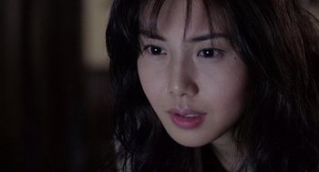 Movie still from “Ringu” (1998), directed by Hideo Nakata – A person with long hair; Close Up shot, Over the shoulder angle