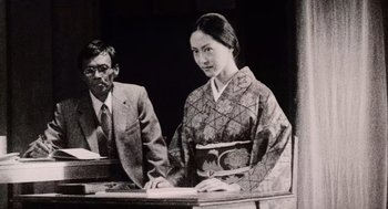 Movie still from “Ringu” (1998), directed by Hideo Nakata – An old photo of a man and a woman; Medium shot, Low angle