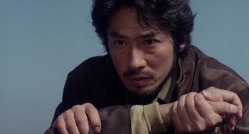 Movie still from “Ringu” (1998), directed by Hideo Nakata – A person with a hand on his shoulder; Close Up shot, Low angle