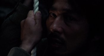 Movie still from “Ringu” (1998), directed by Hideo Nakata – A person holding on to a rope; Extreme Close Up shot, High angle