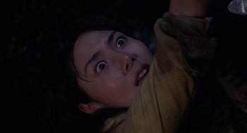 Movie still from “Ringu” (1998), directed by Hideo Nakata – A young girl with a surprised look on her face; Close Up shot, Low angle