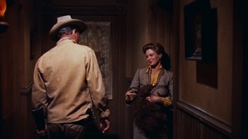Movie still from “Rio Bravo” (1959), directed by Howard Hawks – A man and a woman talking in a room; Medium shot, Over the shoulder angle