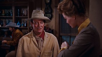 Movie still from “Rio Bravo” (1959), directed by Howard Hawks – A man and a woman talking in a room; Medium shot, Over the shoulder angle