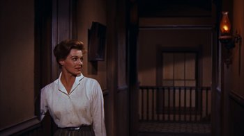 Movie still from “Rio Bravo” (1959), directed by Howard Hawks – A woman standing in front of a door; Medium shot, Over the shoulder angle