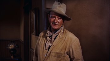 Movie still from “Rio Bravo” (1959), directed by Howard Hawks – A person wearing a hat; Medium shot, Low angle
